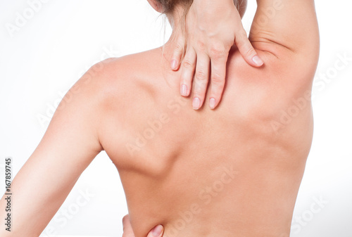 Woman has neck pain. Nude shoulders girl from the back.