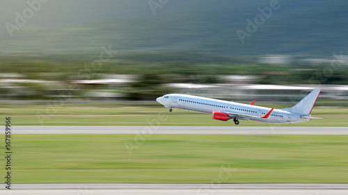 Quadro su tela Airplane Take Off or Landing above Runway with Motion Blur Effect
