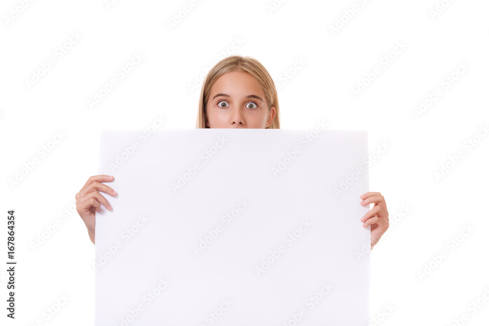 Surprised teen girl behind empty board, isolated Surprised teen girl behind empty board, isolated
