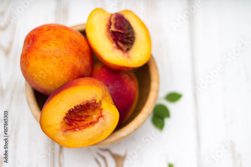 a lot of fresh peaches on a white table