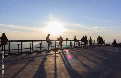 Many tourists watch the morning sunrise on the mountain.