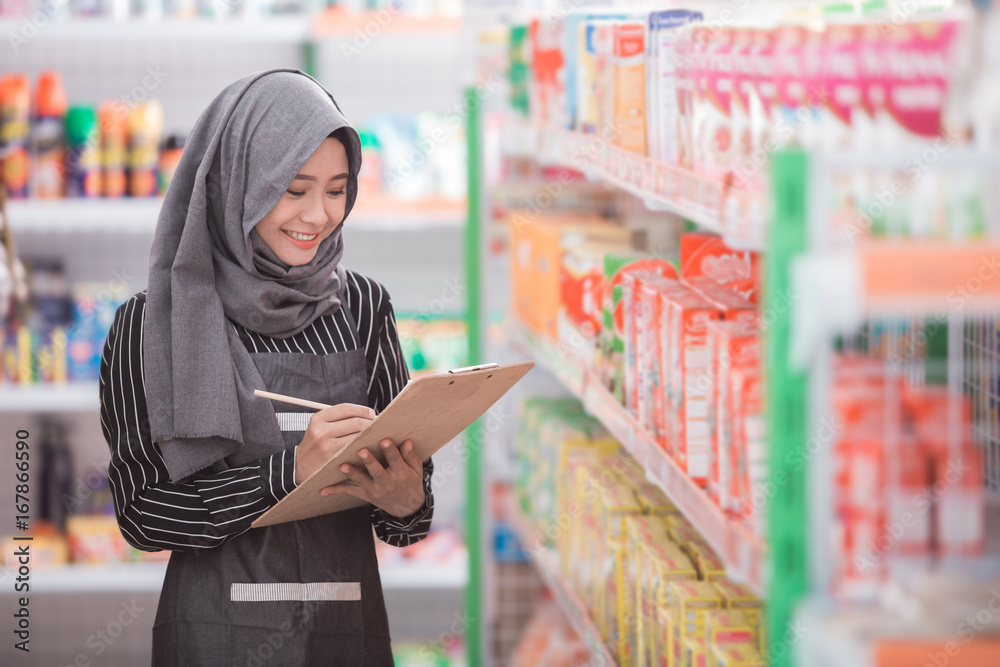 muslim woman checking the product at the store muslim woman checking the product at the store