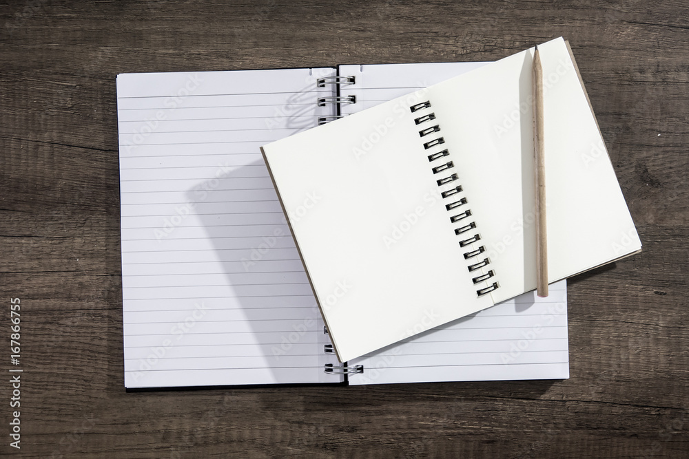 Top view notebook paper on wooden background. Concept for business and education.