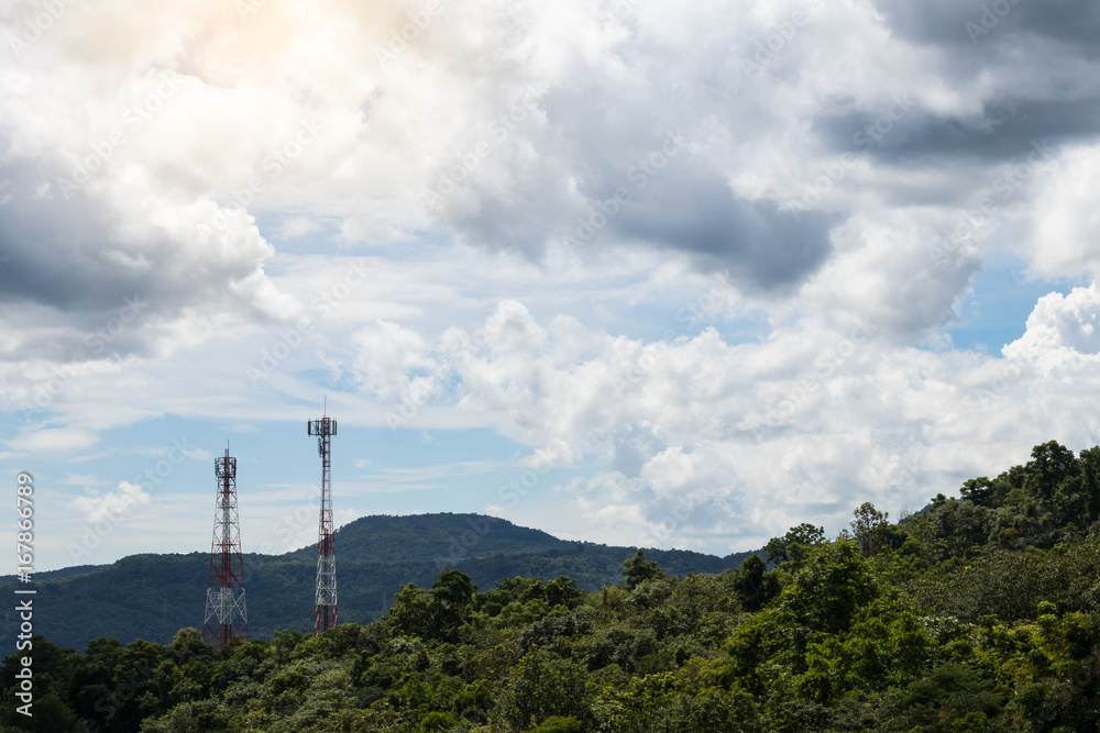 Lush mountains with telecommunication towers.