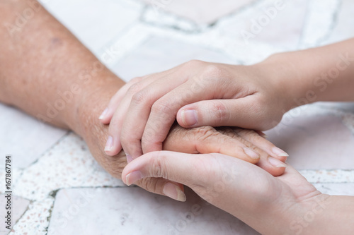 Old and young holding hands  Care for the elderly concept