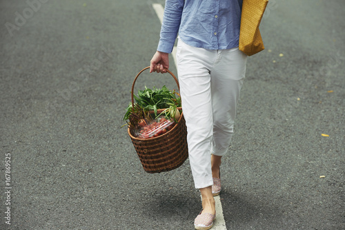 Bringing basket of vegetables photo