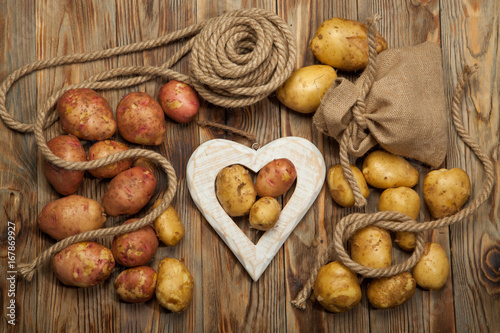 Raw potatoes on a wooden background