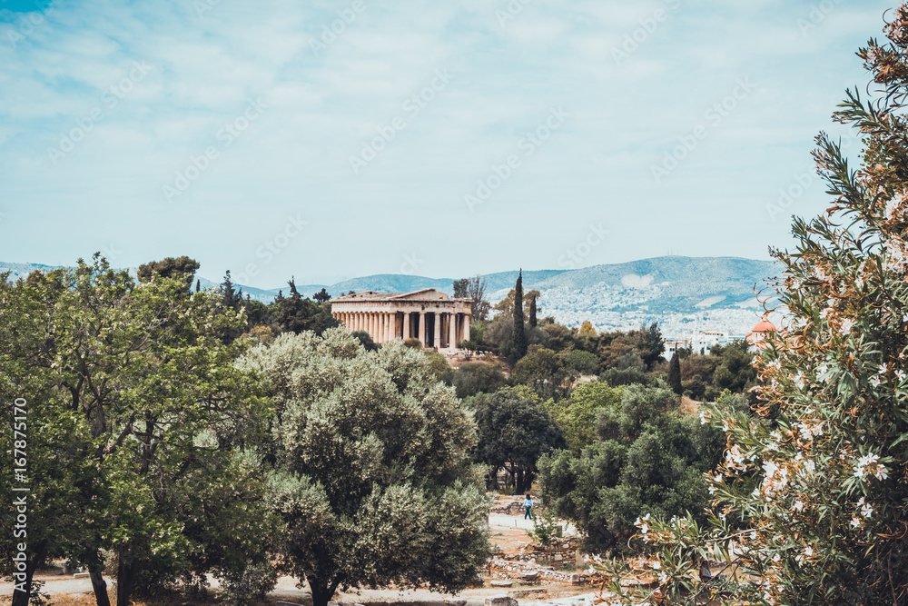 Orchard with ancient Greek temple in background