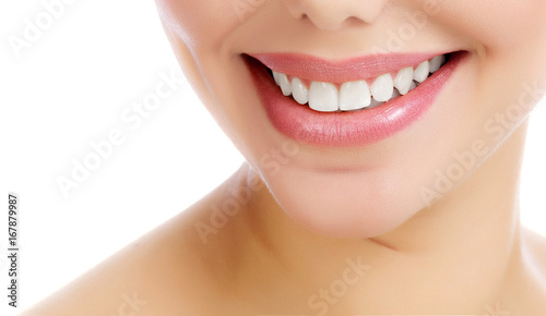Closeup shot of cheerful smiling female with fresh clear skin, white background, isolated
