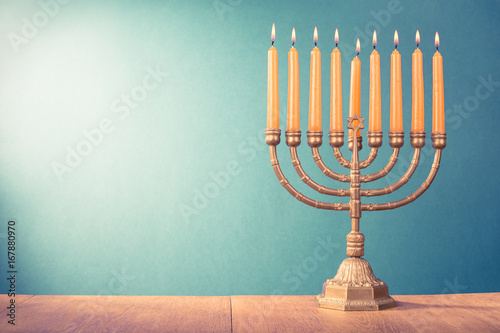Hanukkah menorah with burning candles for holiday card background. Retro old style filtered photo