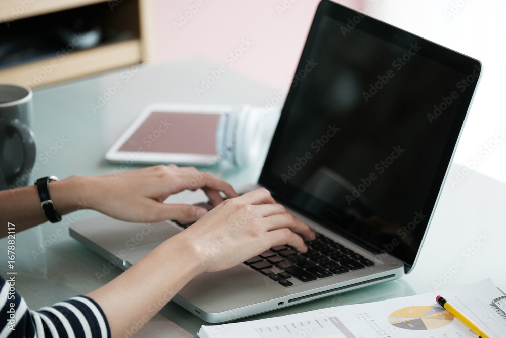 Woman hands typing laptop computer at office desk background, office lifestyle, business and technology Woman hands typing laptop computer at office desk background, office lifestyle, business and technology