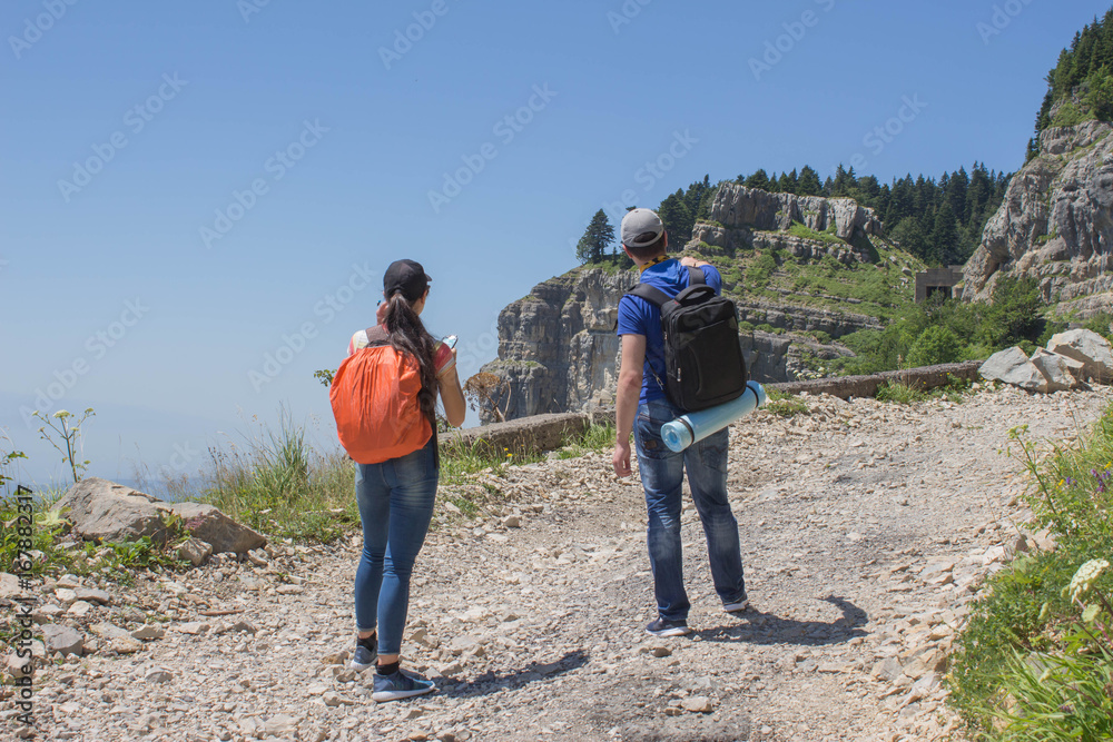 Traveller looking the nature from the high mountain with spotting scope, binoculars tripod