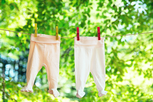 Baby clothes hanging on the clothesline. © nataliaderiabina