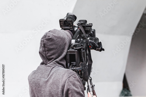 Back view of a professional TV camera man photo