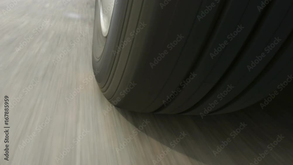 Car wheel spinning, Close UP / Detail Shot / POV - Point of View, day. Fast speed.