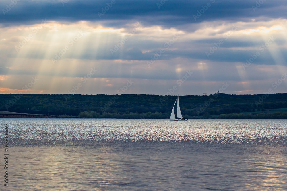 white sail in the sun on the river Volga