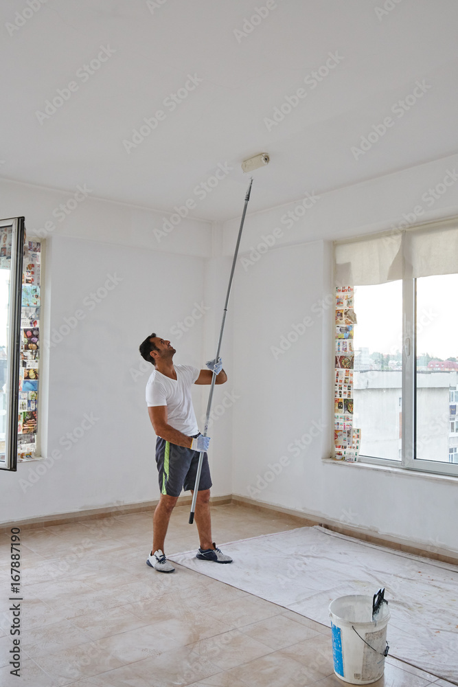 Indian worker painting walls Indian worker painting walls