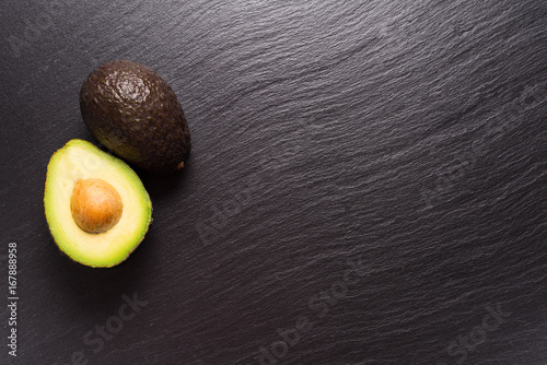 Avocado on black stone background