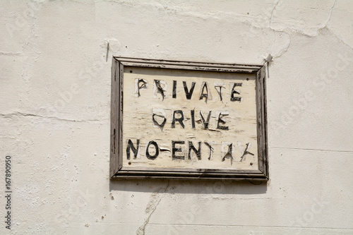 Peeling Private Drive No Entry sign on wall