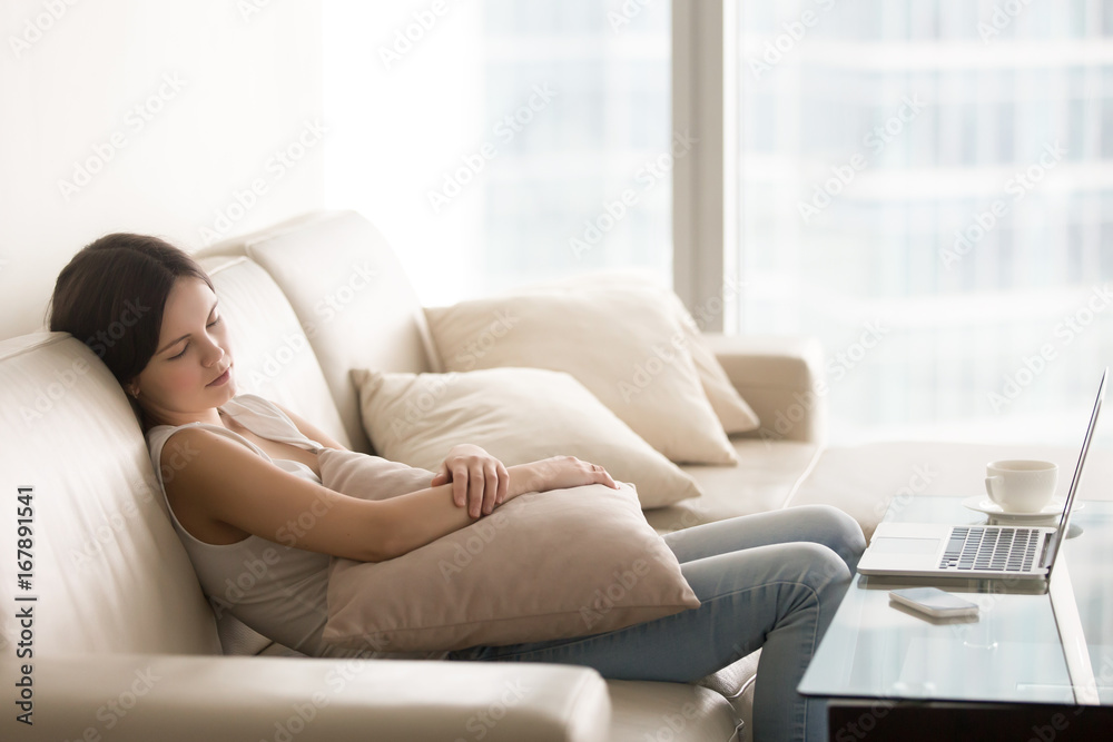 Young pretty woman sleeping on couch in daytime, lazy girl relaxing after computer work, bored teen slumbering during rest break sitting on sofa, taking a nap, falling asleep, dozing at home interior Young pretty woman sleeping on couch in daytime, lazy girl relaxing after computer work, bored teen slumbering during rest break sitting on sofa, taking a nap, falling asleep, dozing at home interior
