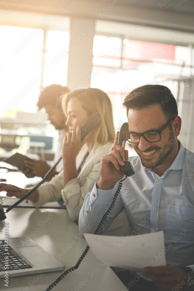 People in operations center talking on Landline phone. Operators in the office. People in operations center talking on Landline phone. Operators in the office.