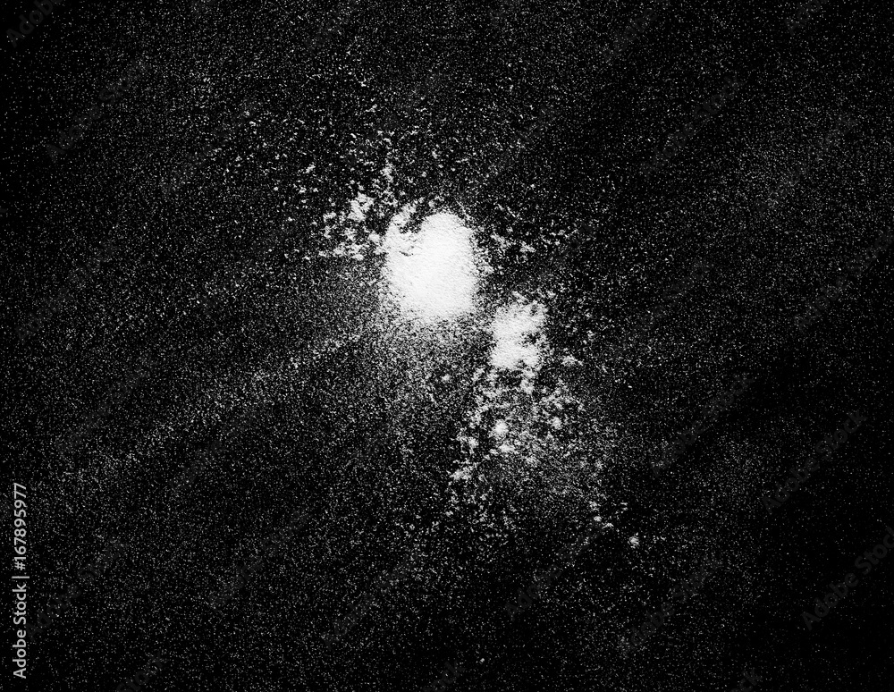 Obraz premium Pile of wheat flour isolated on black background, top view