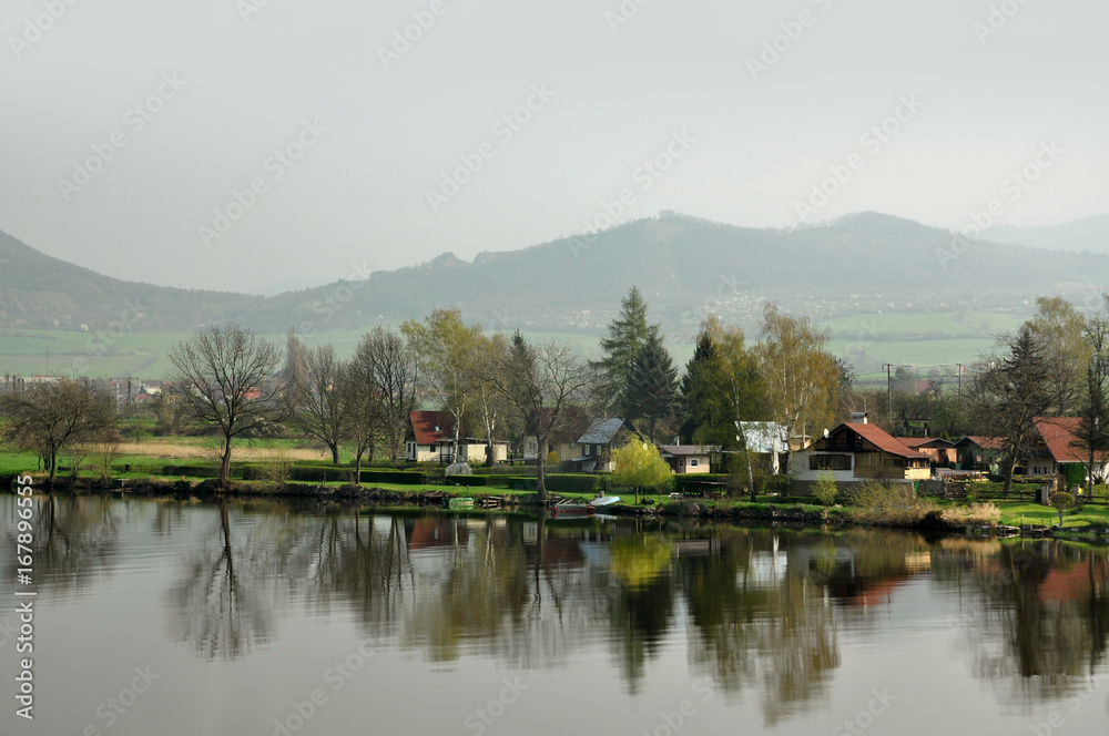 Morning mountain foggy landscape. German village, reflected in the river.