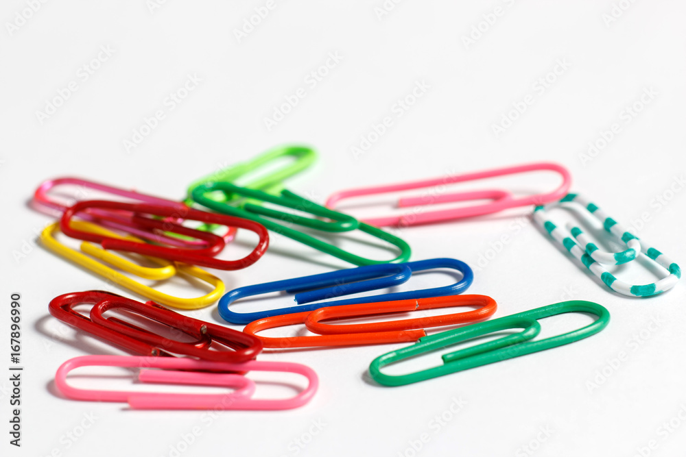 Multicolored paper clips on a white background Multicolored paper clips on a white background