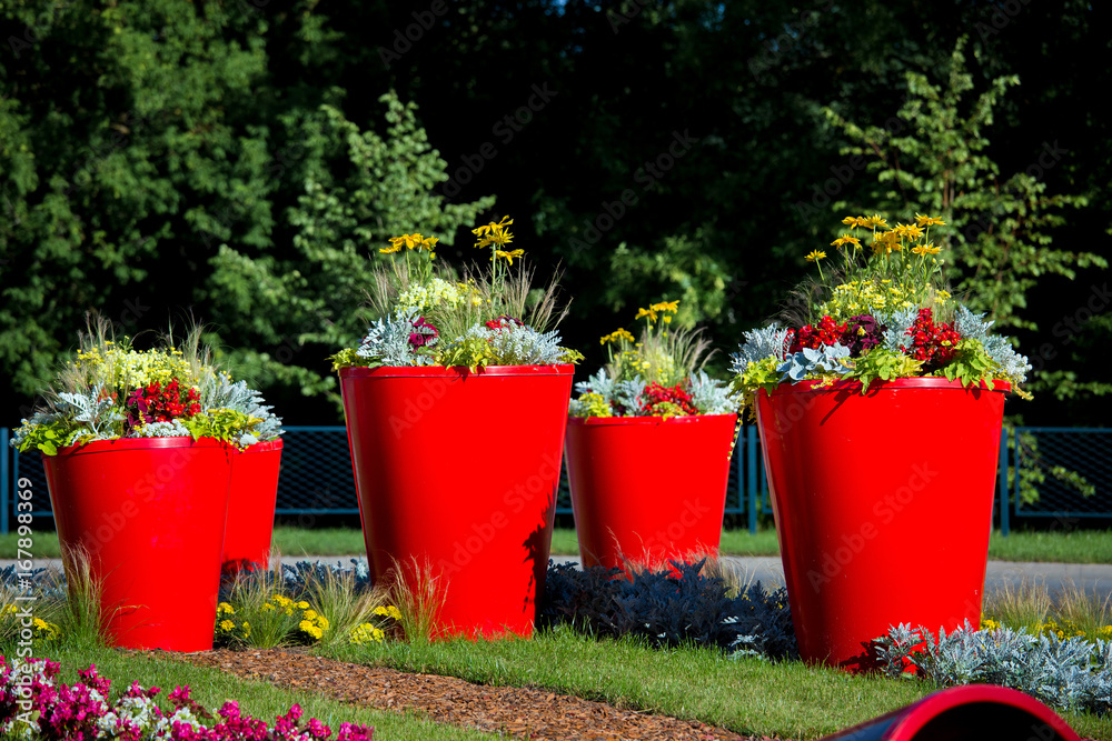Street landscape design, flower city decoration. Red pots with flowers and  plants Stock Photo | Adobe Stock