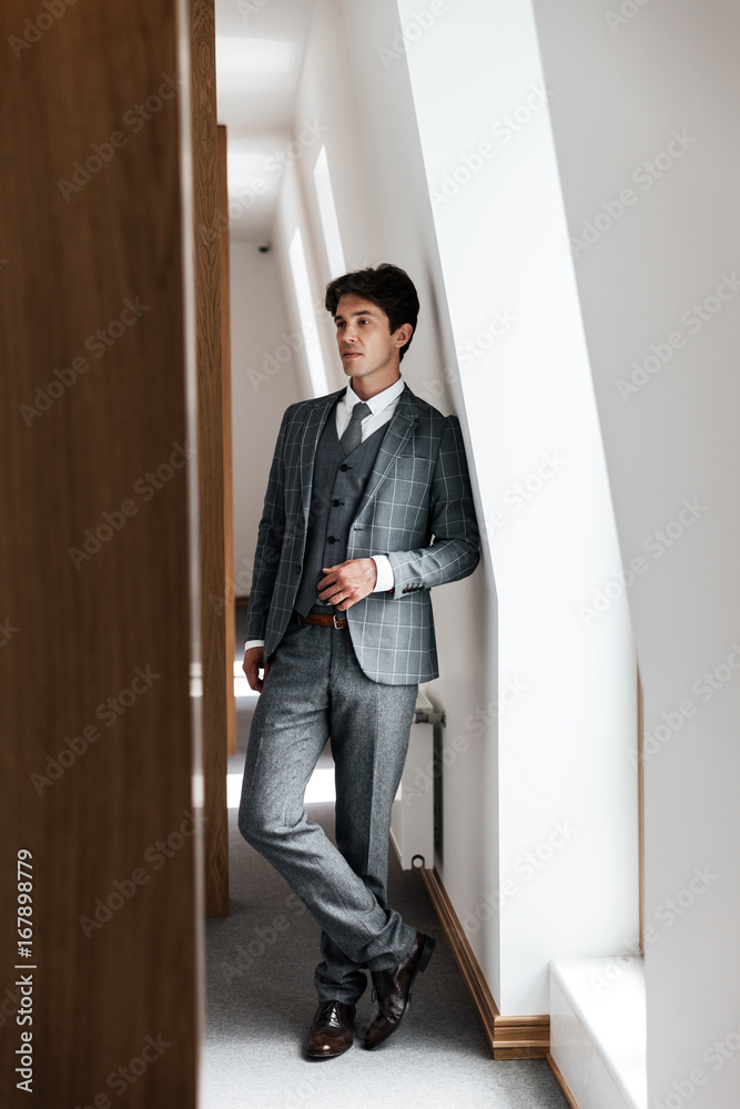 Full length of a confident businessman in suit posing Full length of a confident businessman in suit posing