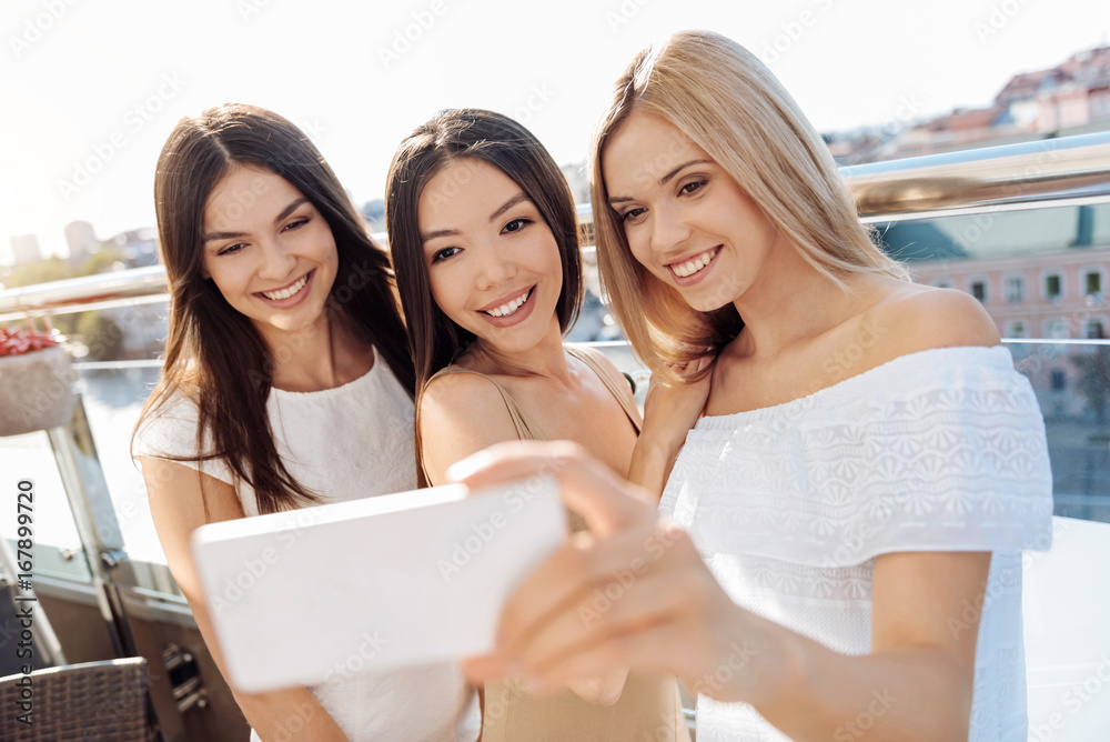 Delighted happy woman taking photos