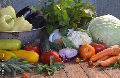 Concept bio organic food. Ingredients for healthy cooking. Vegetables and herbs on wooden background. Preparation of dishes from abbage, cucumber, carrot, zucchini, pepper, onion, eggplant, tomato photo