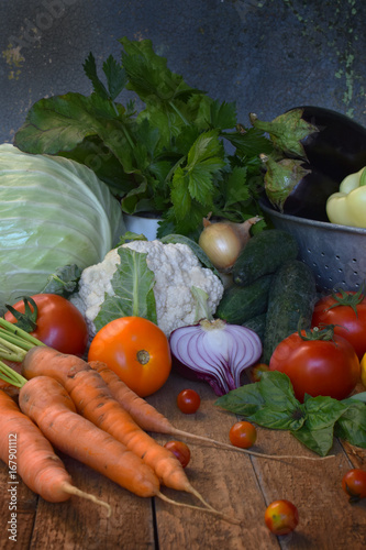 Concept bio organic food. Ingredients for healthy cooking. Vegetables and herbs on wooden background. Preparation of dishes from abbage, cucumber, carrot, zucchini, pepper, onion, eggplant, tomato photo