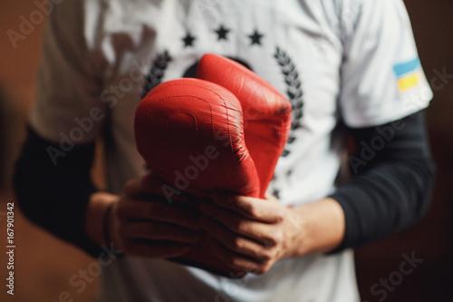 Man holds boxing gloves in his hands