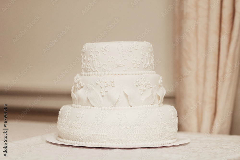 White wedding cake covered with icing White wedding cake covered with icing