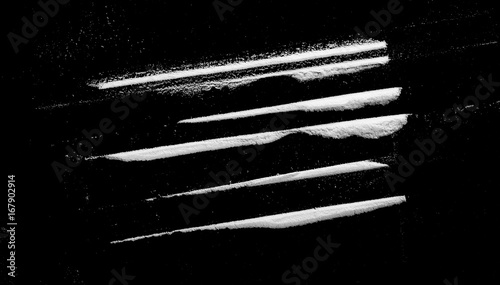 Cocaine lines isolated on black background 