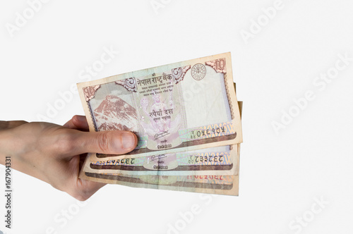 Woman holding thirty Nepal Rupees notes in her hand