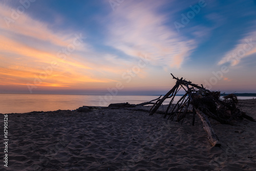 Branch wooden house on tropical beach in sunset time, deserted beach
