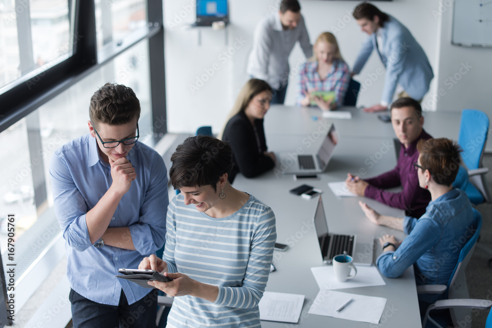 Two Business People Working With Tablet in office Two Business People Working With Tablet in office