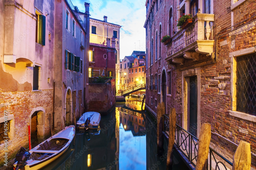 Venetian canal at sunset time.