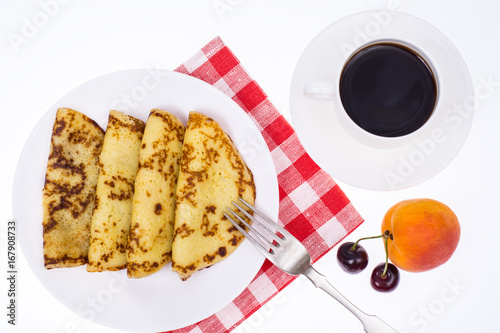 Crispy thin pancakes on plate, light background