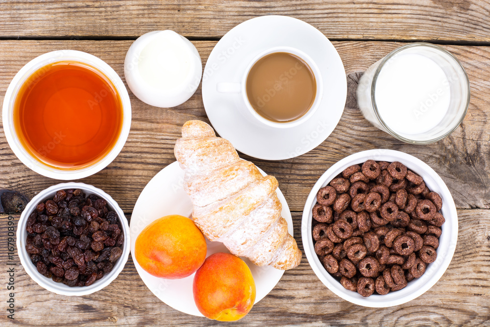 Chocolate cereal flakes, coffee, milk, croissant and fruit for b Chocolate cereal flakes, coffee, milk, croissant and fruit for b