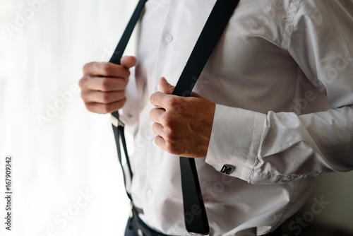 Man keeps himself for suspenders.
