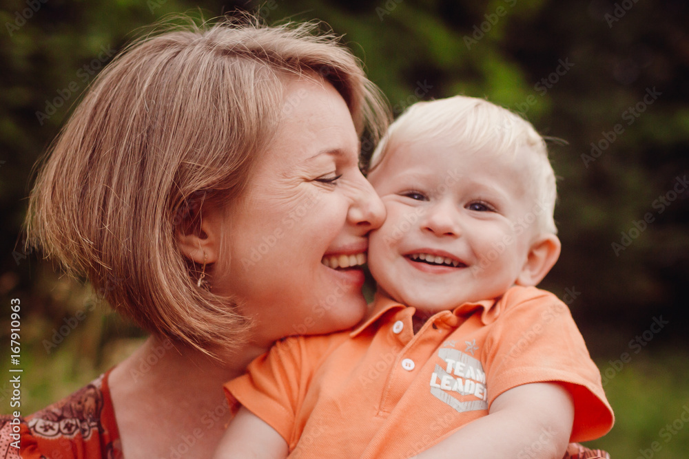 Happy mother holds beautiful little son tender Happy mother holds beautiful little son tender