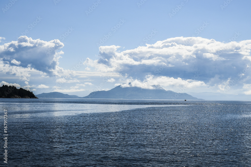 Beautiful landscape on the north sea in norway with clouds on a sunny day