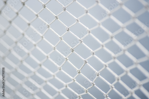 A material net that is a decoration on a yacht, performing protective functions. Texture or background.