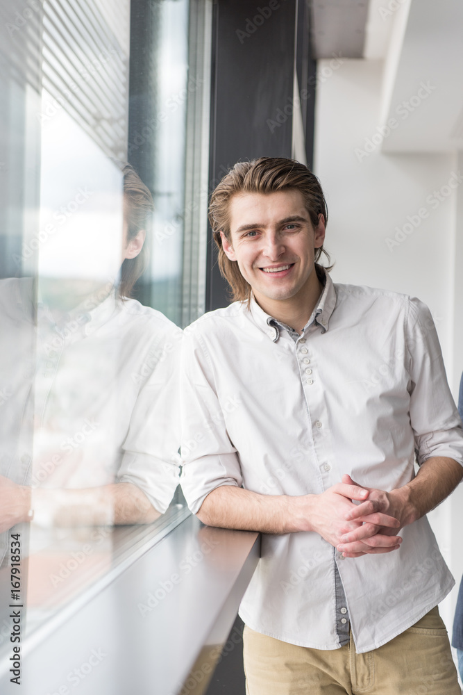 Fototapeta premium young businessman in startup office by the window