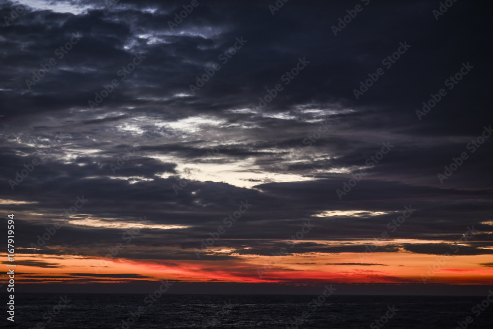Beautiful red sunrise in the northern summer sea
