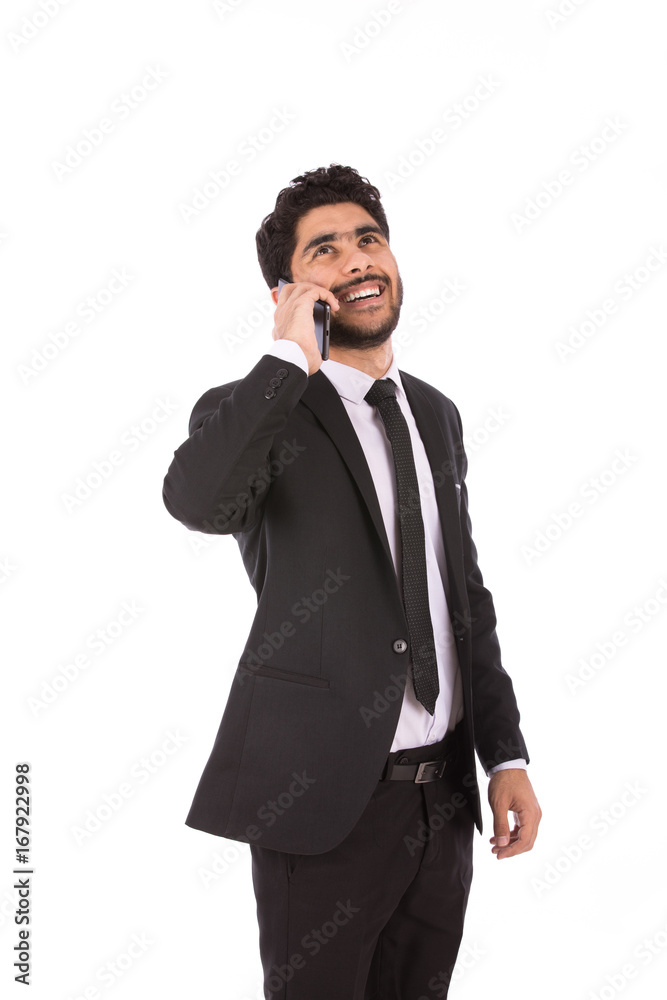 Happy handsome young businessman smiling and making a call, guy wearing black suit and black tie, isolated on white background Happy handsome young businessman smiling and making a call, guy wearing black suit and black tie, isolated on white background