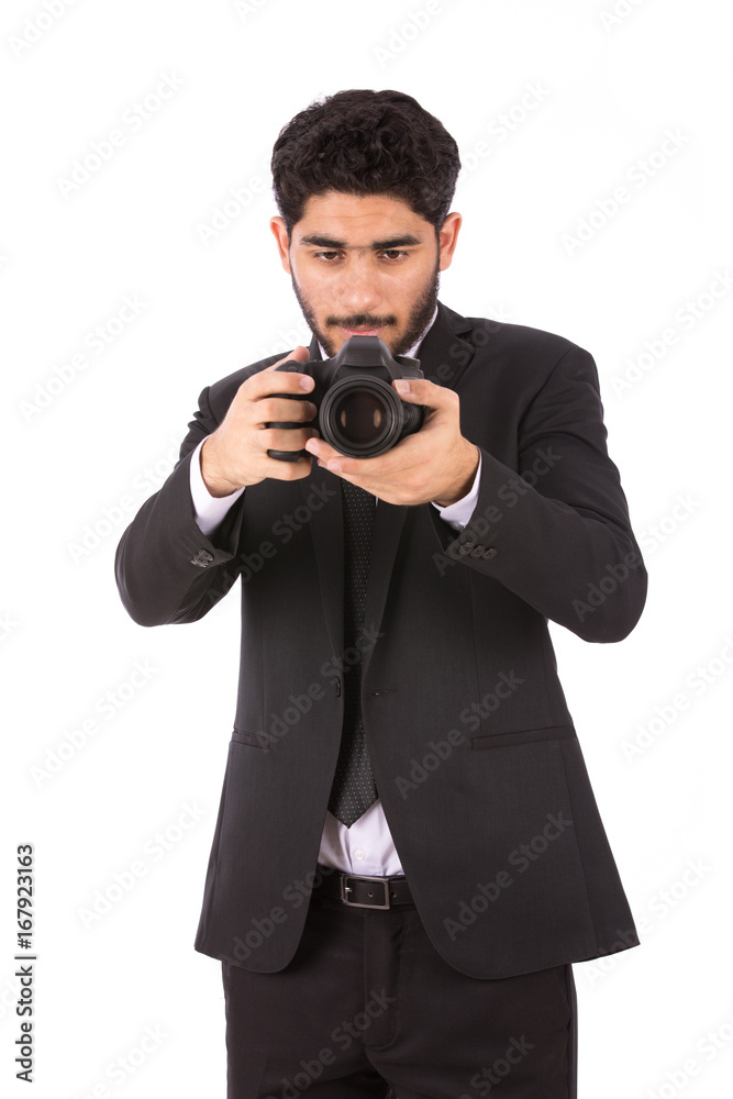 Happy handsome young businessman smiling and taking a photo, guy wearing black suit and black tie, isolated on white background Happy handsome young businessman smiling and taking a photo, guy wearing black suit and black tie, isolated on white background